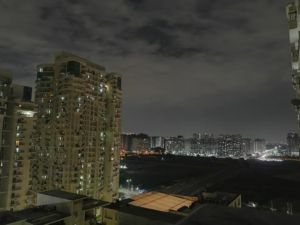 High-rise residential towers in Noida's Sector 78 area at night