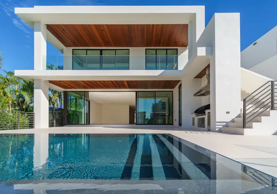 White villa with a pool at dusk